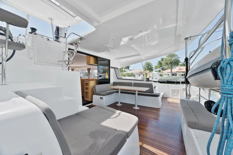 Curvy Mermaid Yacht Photos Pics Spacious deck of 2017 Lagoon 42 catamaran with seating and dining area.