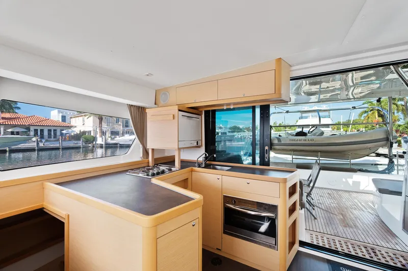 Curvy Mermaid Yacht Photos Pics Interior of 2017 Lagoon 42 yacht with modern kitchen and marina view.