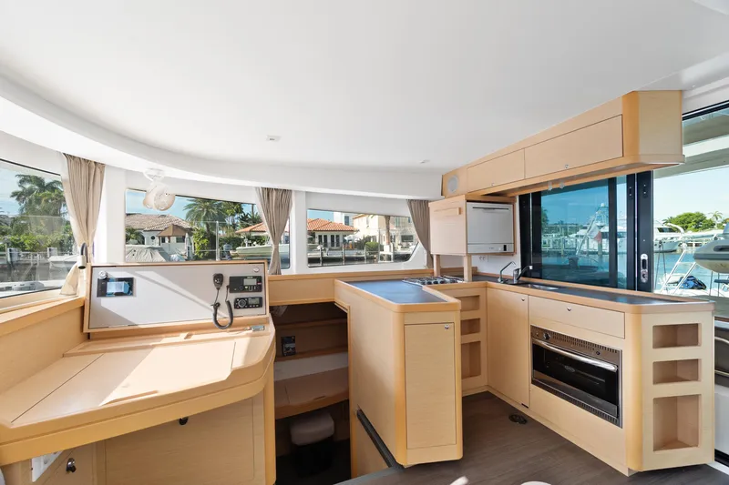 Curvy Mermaid Yacht Photos Pics Interior of 2017 Lagoon 42 catamaran with modern kitchen and navigation area.
