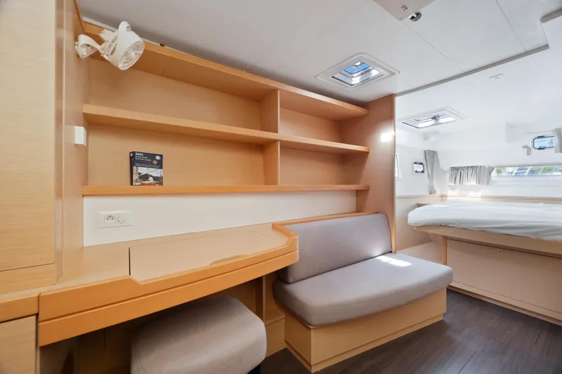 Curvy Mermaid Yacht Photos Pics Luxurious interior of 2017 Lagoon 42 yacht with cozy seating and modern shelving.