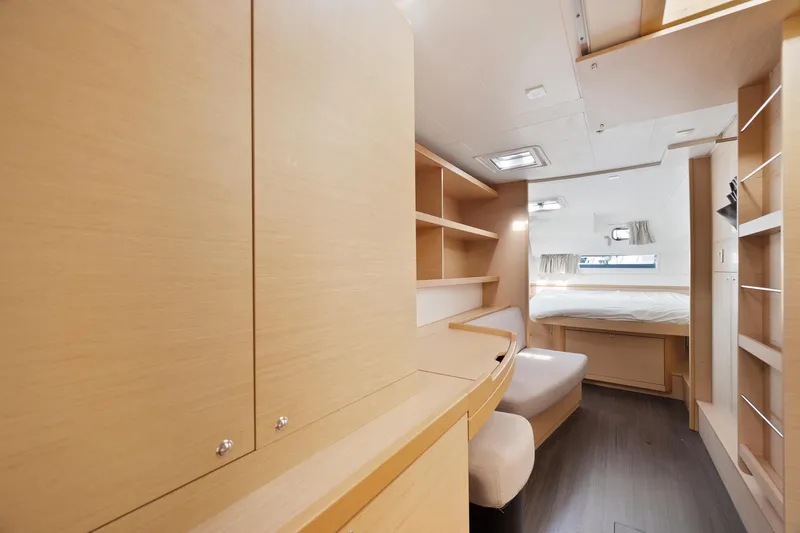 Curvy Mermaid Yacht Photos Pics Interior of 2017 Lagoon 42 catamaran with modern wood finish and cozy sleeping area.
