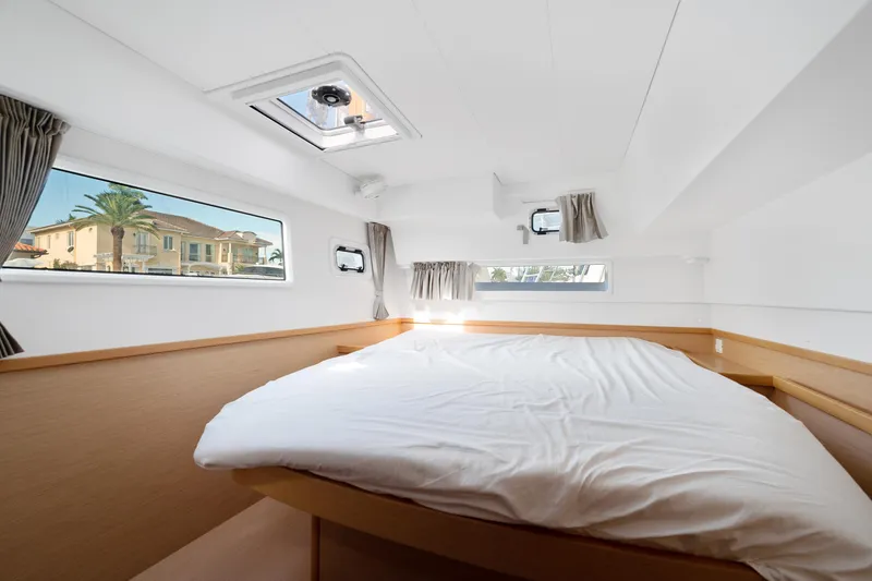 Curvy Mermaid Yacht Photos Pics Interior cabin of 2017 Lagoon 42 catamaran with bed and windows.