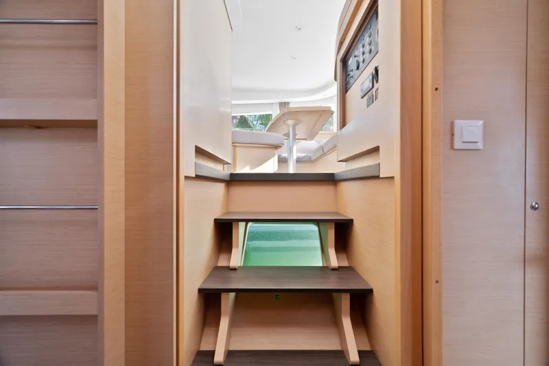 Curvy Mermaid Yacht Photos Pics Interior view of 2017 Lagoon 42 yacht, featuring wooden steps and modern design elements.