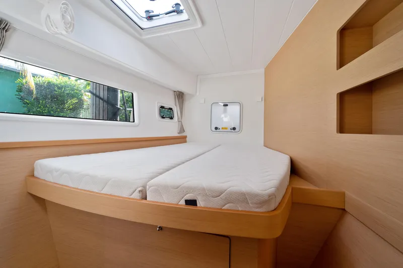 Curvy Mermaid Yacht Photos Pics Interior cabin of 2017 Lagoon 42 catamaran with bed and window view.