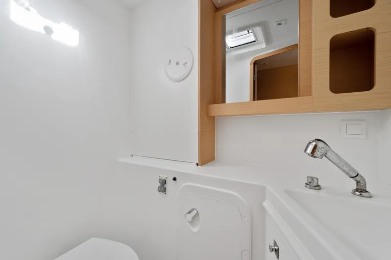 Curvy Mermaid Yacht Photos Pics Modern bathroom interior of 2017 Lagoon 42 yacht, featuring sleek fixtures and wooden accents.