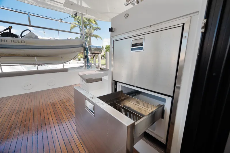Curvy Mermaid Yacht Photos Pics Outdoor kitchen on 2017 Lagoon 42 yacht with stainless steel appliances and wooden deck.