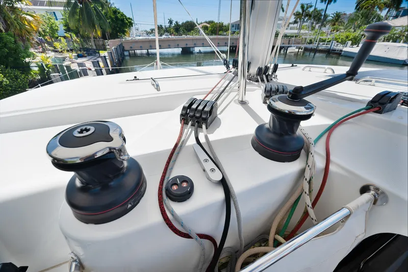 Curvy Mermaid Yacht Photos Pics Deck view of a 2017 Lagoon 42 catamaran, featuring winches and ropes.