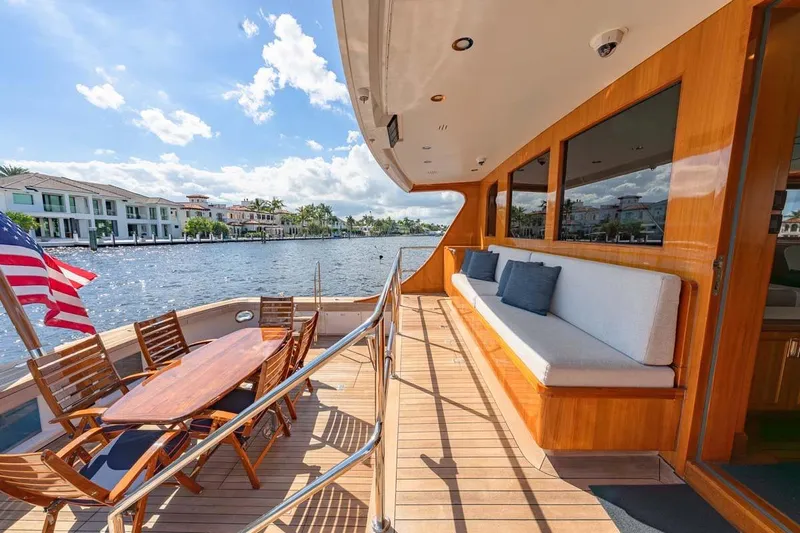 Catch Yacht Photos Pics Luxurious 1984 Feadship Yacht Fish deck with seating, dining area, and waterfront view.