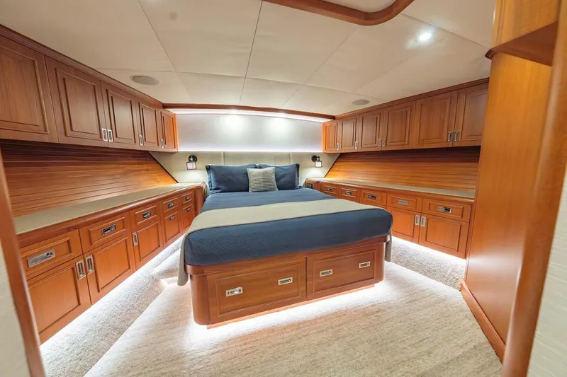 Catch Yacht Photos Pics Luxurious cabin interior of 1984 Feadship Yacht Fish with wood paneling and cozy bed.
