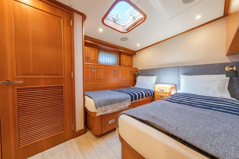 Catch Yacht Photos Pics Luxurious 1984 Feadship Yacht Fish cabin with twin beds and elegant wood finishes.
