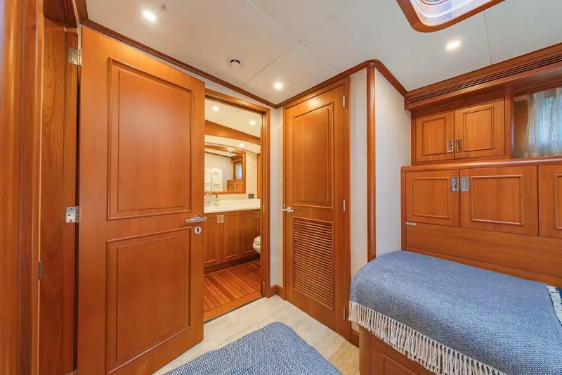 Catch Yacht Photos Pics Luxurious 1984 Feadship Yacht Fish cabin with wooden interior and cozy bedding.
