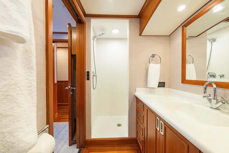 Catch Yacht Photos Pics Luxurious bathroom on 1984 Feadship Yacht Fish, featuring wooden accents and modern fixtures.