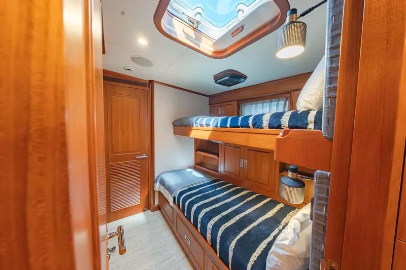 Catch Yacht Photos Pics Luxurious 1984 Feadship Yacht Fish cabin with wooden interior and bunk beds.