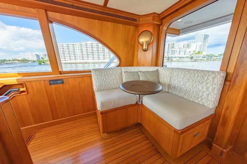 Catch Yacht Photos Pics Luxurious 1984 Feadship Yacht Fish interior with elegant wood paneling and cozy seating area.