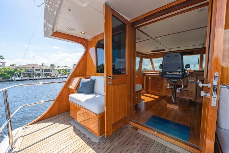 Catch Yacht Photos Pics Luxurious 1984 Feadship Yacht Fish interior with wooden finish and waterfront view.