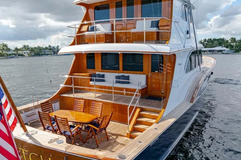 Catch Yacht Photos Pics Luxurious 1984 Feadship Yacht Fish with elegant wooden deck and outdoor seating.