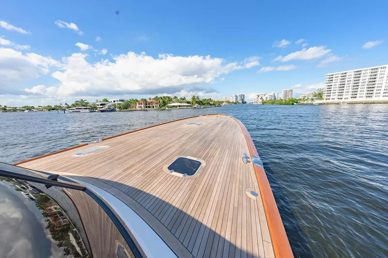 Catch Yacht Photos Pics Luxurious 1984 Feadship Yacht Fish on calm waters, clear sky, and scenic waterfront view.