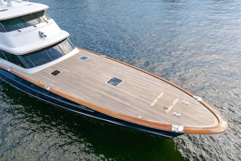 Catch Yacht Photos Pics 1984 Feadship Yacht Fish with sleek wooden deck on calm water.