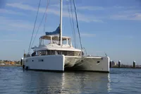 2013 Lagoon 52 F catamaran on calm water, clear sky background.