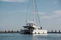 2013 Lagoon 52 F catamaran docked in calm waters under a clear sky.