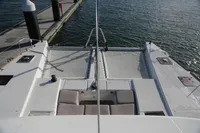2013 Lagoon 52 F catamaran docked, featuring spacious deck and netting area.