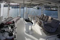 Spacious cockpit of 2013 Lagoon 52 F yacht with seating and steering wheel.