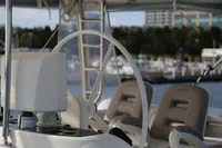 Helm of 2013 Lagoon 52 F catamaran with marina in background.