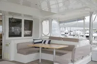Spacious Lagoon 52 F catamaran interior with seating area, 2013 model, docked at marina.