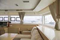 Interior of 2013 Lagoon 52 F yacht, featuring spacious seating and large windows.