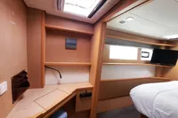 Interior of 2013 Lagoon 52 F yacht cabin with desk, bed, and TV.