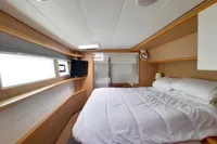 Luxurious cabin interior of 2013 Lagoon 52 F yacht with cozy bed and modern amenities.