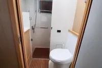 2013 Lagoon 52 F yacht bathroom with shower and toilet, featuring wooden flooring.