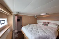 Luxurious cabin interior of 2013 Lagoon 52 F yacht with cozy bed and ensuite bathroom.