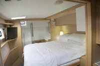 Luxurious cabin interior of 2013 Lagoon 52 F yacht with cozy bed and modern amenities.