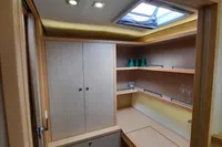 Interior of 2013 Lagoon 52 F yacht with wooden cabinetry and skylight.