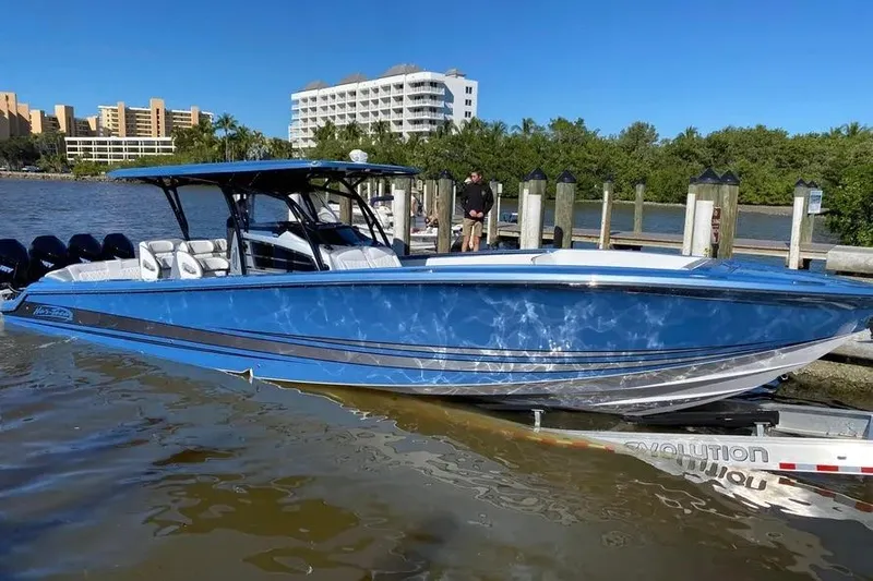  Yacht Photos Pics 2021 Nor-Tech 390 Sport Center Console boat docked, with blue hull and sleek design.
