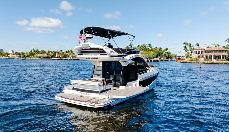 Lei Vola Yacht Photos Pics 2022 Galeon 400 Fly yacht cruising on a sunny day in a scenic waterway.