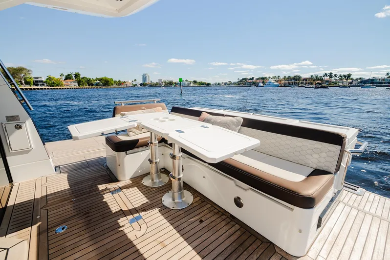 Lei Vola Yacht Photos Pics Galeon 400 Fly 2022 yacht deck with seating and table, overlooking serene water.