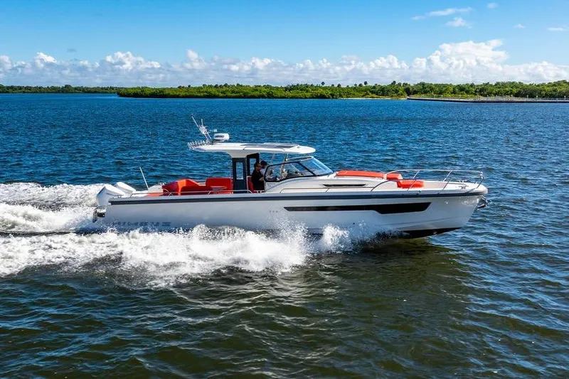  Yacht Photos Pics 2023 Nimbus Tender 11 cruising on a sunny day, showcasing sleek design and performance.