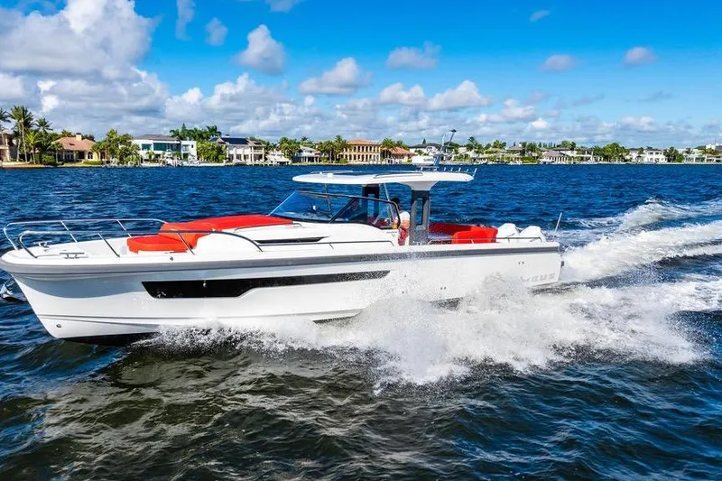  Yacht Photos Pics 2023 Nimbus Tender 11 cruising on a sunny day, with vibrant red seating.