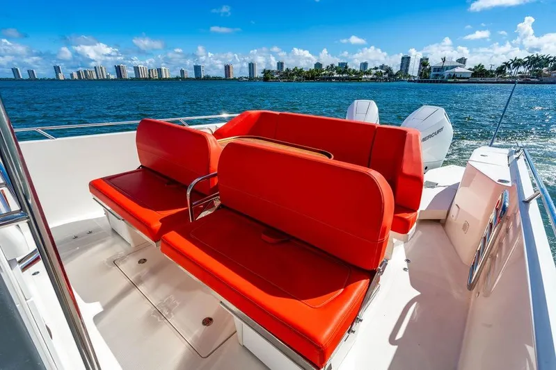  Yacht Photos Pics 2023 Nimbus Tender 11 with vibrant red seating, cruising on a sunny day.