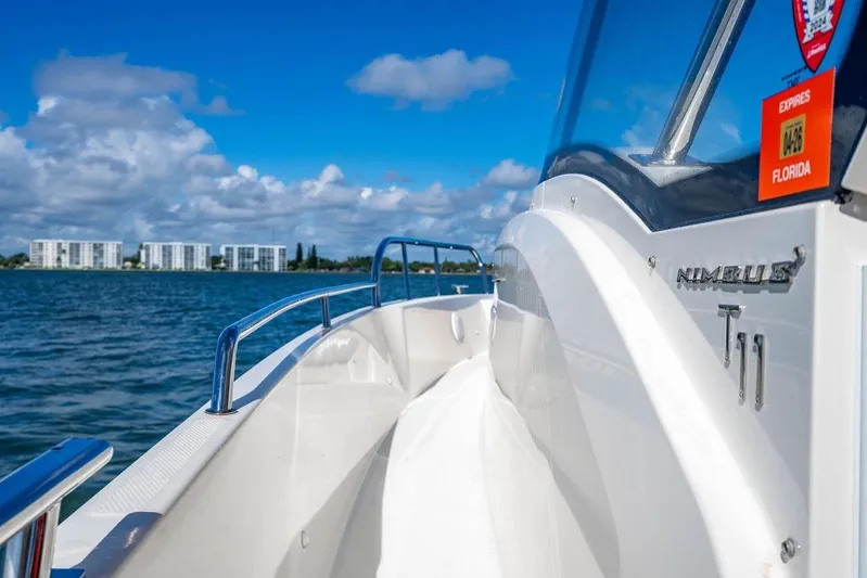  Yacht Photos Pics 2023 Nimbus Tender 11 boat cruising on a sunny day near Florida coastline.