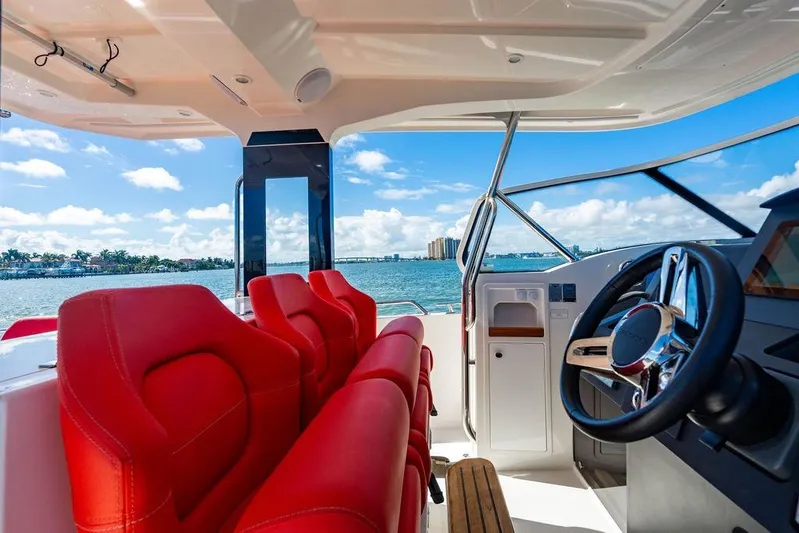  Yacht Photos Pics Interior of 2023 Nimbus Tender 11 with red seats and ocean view.