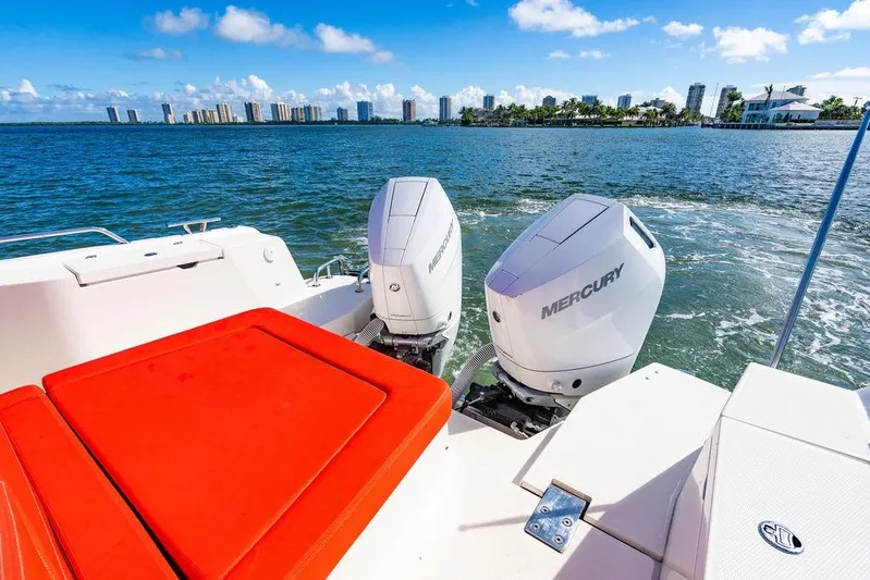  Yacht Photos Pics 2023 Nimbus Tender 11 with Mercury engines cruising near city skyline.