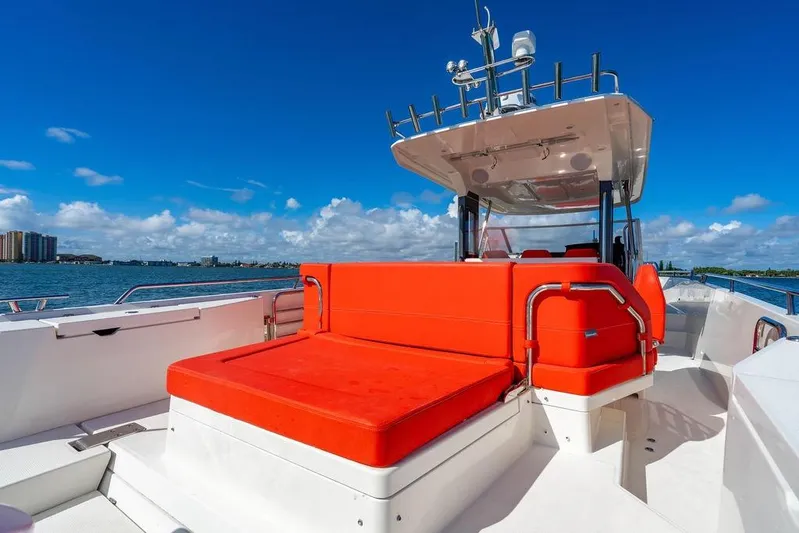  Yacht Photos Pics 2023 Nimbus Tender 11 boat with vibrant red seating on a sunny day.