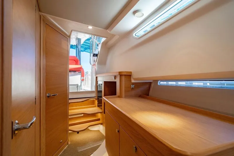  Yacht Photos Pics Interior of 2023 Nimbus Tender 11, featuring wooden cabinetry and modern design.