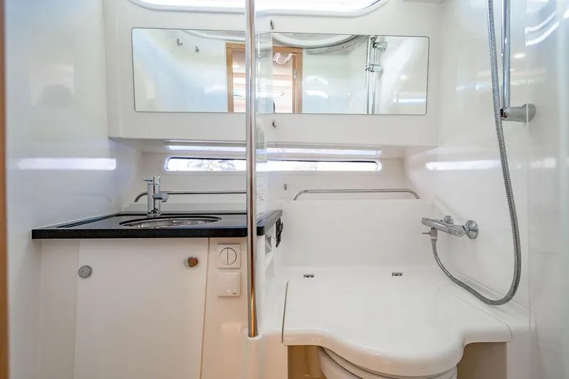  Yacht Photos Pics 2023 Nimbus Tender 11 bathroom with modern sink, mirror, and shower.
