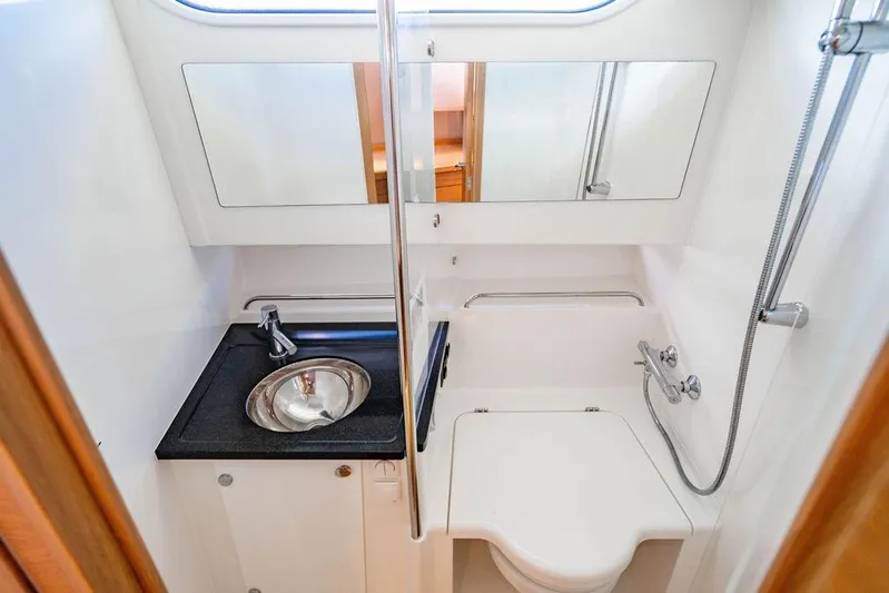  Yacht Photos Pics 2023 Nimbus Tender 11 bathroom with sink, mirror, and shower.