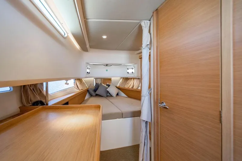  Yacht Photos Pics Interior of 2023 Nimbus Tender 11 yacht with cozy cabin and wooden finishes.