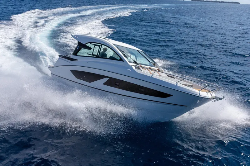  Yacht Photos Pics 2024 Beneteau Gran Turismo 32 Inboard cruising on open sea, creating dynamic waves.